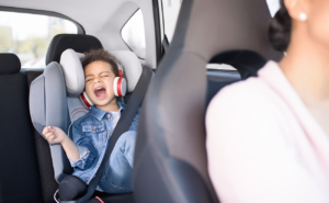 Child in backset of car throwing a tantrum